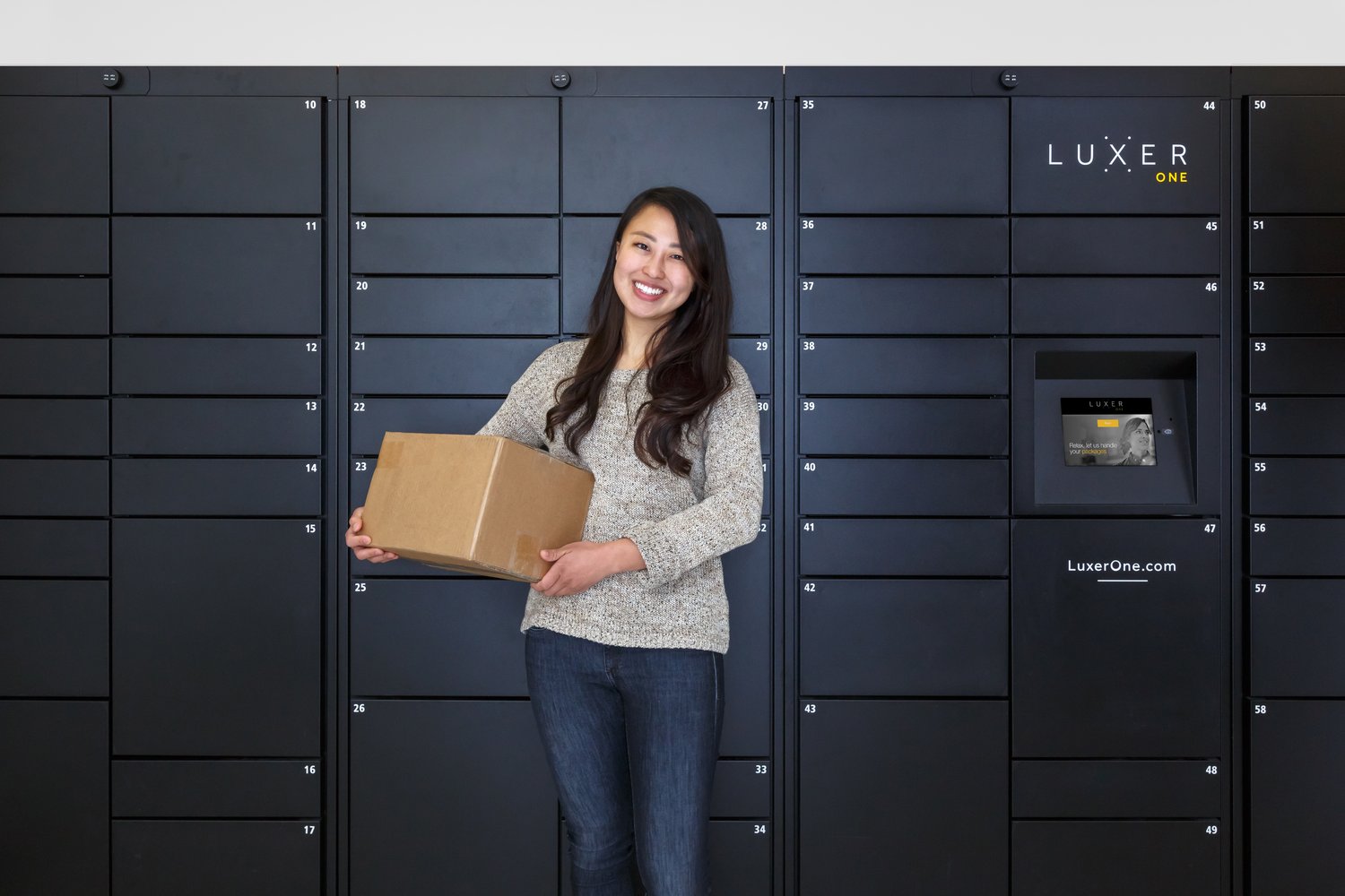 Transact Campus and Luxer One Lockers with asian girl holding her delivery